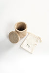 A travertine box with soy wax beads