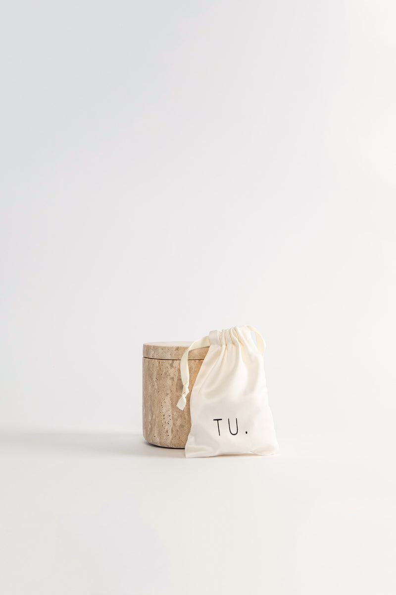 A travertine box with soy wax beads